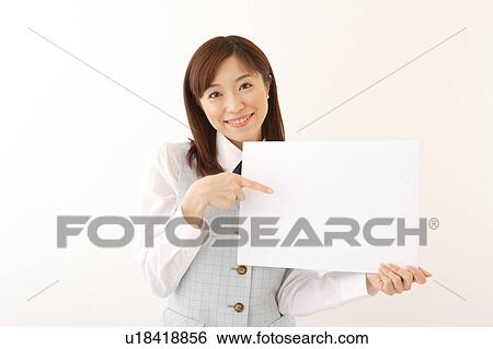 A woman in formal attire holding a white blank message View Large Photo Image Stock Photograph - A woman in formal attire holding a white blank message. Fotosearch