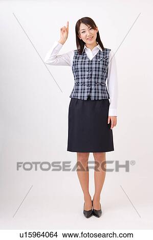 Picture - A woman in formal attire pointing a direction. Fotosearch
