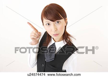 Picture - A woman in formal attire pointing a direction. Fotosearch