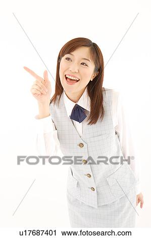 Stock Image - A woman in formal attire pointing a direction. Fotosearch