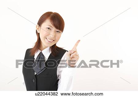 Stock Image - A woman in formal attire pointing a direction. Fotosearch