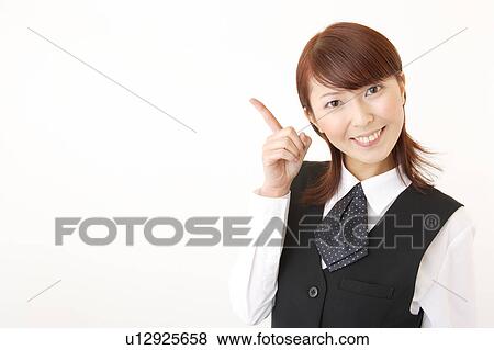 Stock Photo - A woman in formal attire pointing a direction. Fotosearch