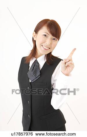 Stock Photograph - A woman in formal attire pointing a direction. Fotosearch