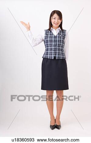 A woman in formal attire showing a direction View Large Photo Image Stock Image - A woman in formal attire showing a direction. Fotosearch