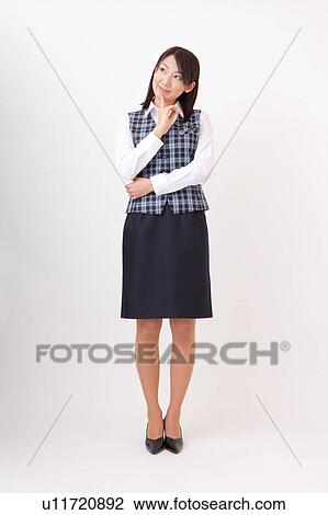 Stock Image - A woman in formal attire wondering. Fotosearch