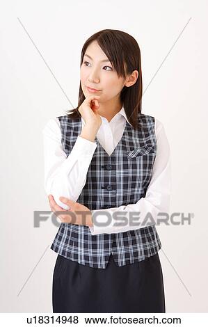 Stock Photo - A woman in formal attire wondering. Fotosearch