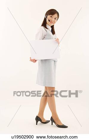 Stock Image - A woman with headset holding a blank message. Fotosearch