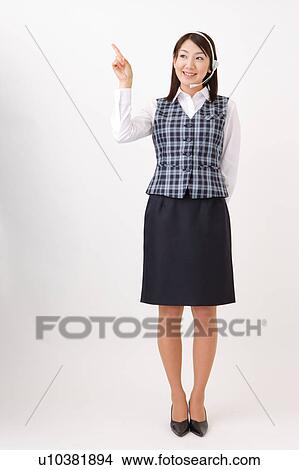 A woman with headset pointing a direction View Large Photo Image Picture - A woman with headset pointing a direction. Fotosearch