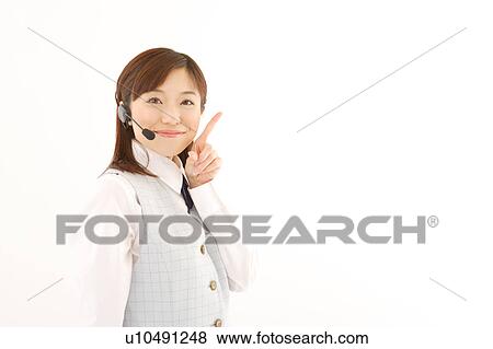 Stock Photo - A woman with headset pointing a direction. Fotosearch