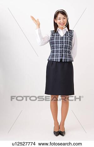A woman with headset showing a direction View Large Photo Image Picture - A woman with headset showing a direction. Fotosearch