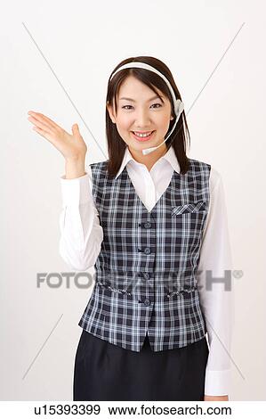 A woman with headset showing a direction View Large Photo Image Stock Photo - A woman with headset showing a direction. Fotosearch