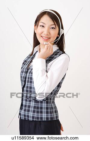 Picture - A woman with headset smiling. Fotosearch