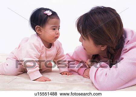 Stock Photo - A baby staring at mother. Fotosearch
