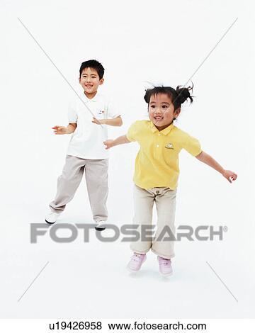 Stock Photo - A boy and a girl dancing. Fotosearch