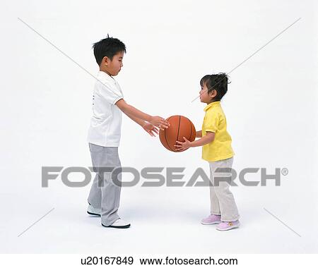 Stock Photo - A boy and a girl playing with a basketball. Fotosearch