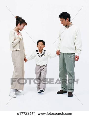 Picture - A boy holding hands with his parents. Fotosearch