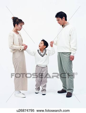 Stock Photography - A boy holding hands with his parents. Fotosearch