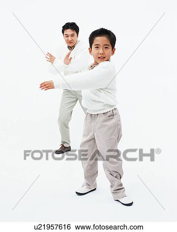 Stock Photograph - A boy posing with his father. Fotosearch