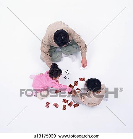 A father playing card with his children View Large Photo Image Stock Photo - A father playing card with his children. Fotosearch