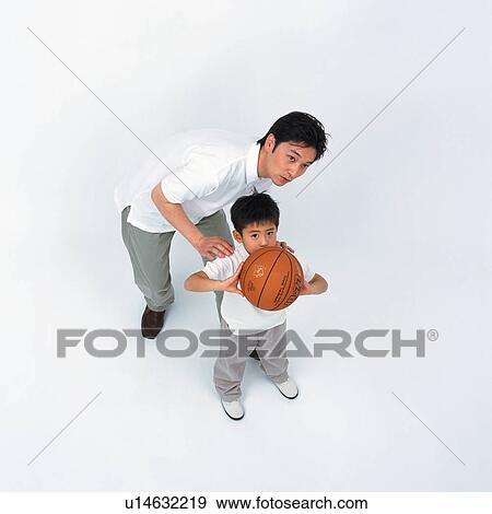 A father teaching his son to play basketball View Large Photo Image Stock Photo - A father teaching his son to play basketball. Fotosearch