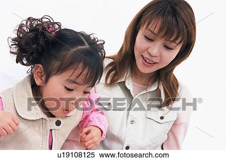 Stock Photography - A girl in action to blow off. Fotosearch