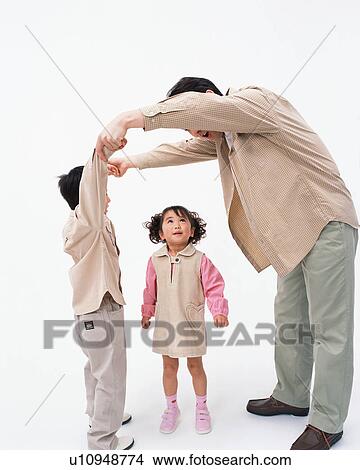Picture - A girl playing with her father and brother. Fotosearch