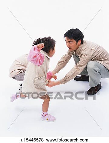 Stock Photo - A girl playing with her parents. Fotosearch