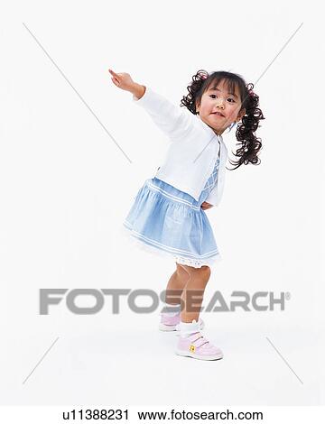 Stock Image - A girl pointing at a direction. Fotosearch