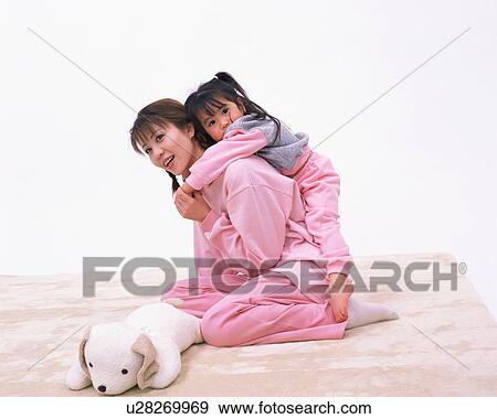 A girl resting on her mother's back View Large Photo Image Stock Photo - A girl resting on her mother's back. Fotosearch