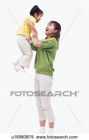 A mother hoisting her daughter in excitement View Large Photo Image Stock Photography - A mother hoisting her daughter in excitement. Fotosearch