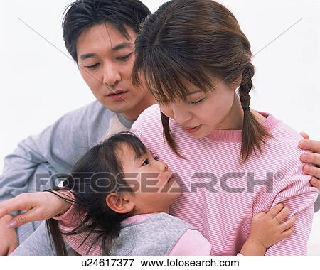 Stock Photo - A mother holding her daughter in her arms. Fotosearch