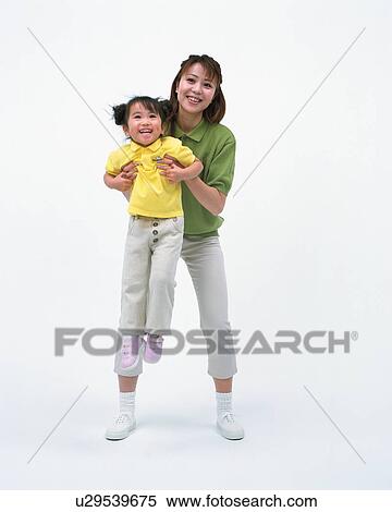 Stock Photography - A mother lifting up her daughter. Fotosearch