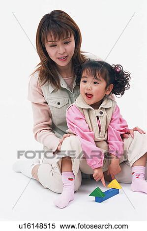 Stock Photography - A mother playing with her daughter. Fotosearch