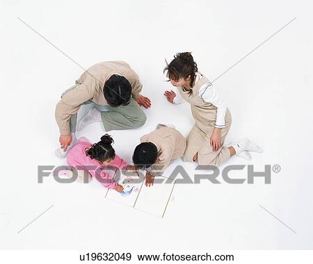 Children drawing a human face and parents looking on View Large Photo Image Stock Photo - Children drawing a human face and parents looking on. Fotosearch