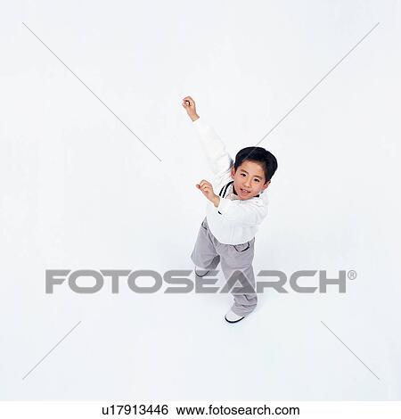 Stock Photograph - High angle view of a small boy with raised hands. Fotosearch