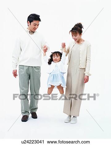Stock Image - Parents lifting their daughter. Fotosearch
