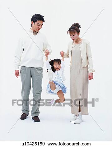 Stock Photo - Parents lifting their daughter. Fotosearch