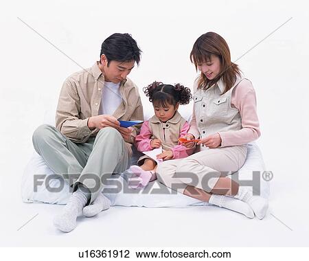 Stock Image - Parents playing with their daughter . Fotosearch