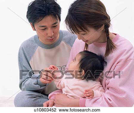 Parents sharing an affectionate moment with their baby View Large Photo Image Stock Image - Parents sharing an affectionate moment with their baby. Fotosearch
