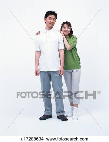 Portrait of a couple posing in front of a camera View Large Photo Image Picture - Portrait of a couple posing in front of a camera. Fotosearch