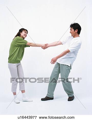 Side view of a woman pulling her husband's hand View Large Photo Image Stock Photo - Side view of a woman pulling her husband's hand. Fotosearch