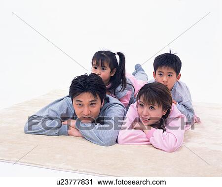 Stock Image - Two children resting on their parents' back. Fotosearch