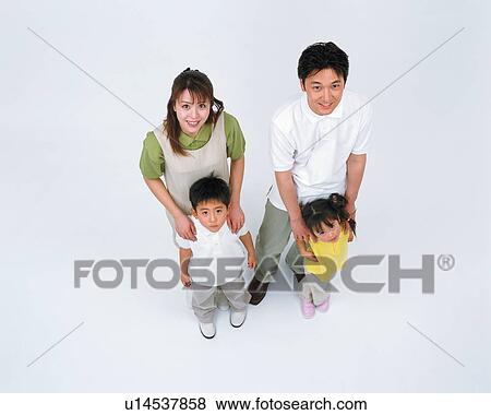 A family in stance looking up at camera View Large Photo Image Stock Photo - A family in stance looking up at camera. Fotosearch