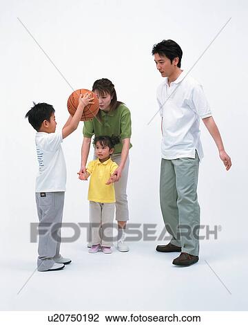 Stock Image - A family playing with a basketball. Fotosearch