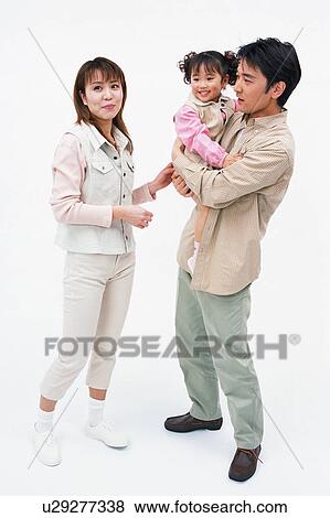 Stock Photo - A father carrying a daughter and a mother watching. Fotosearch