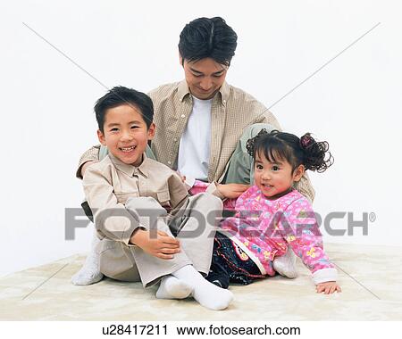 Stock Image - A father playing with his children. Fotosearch