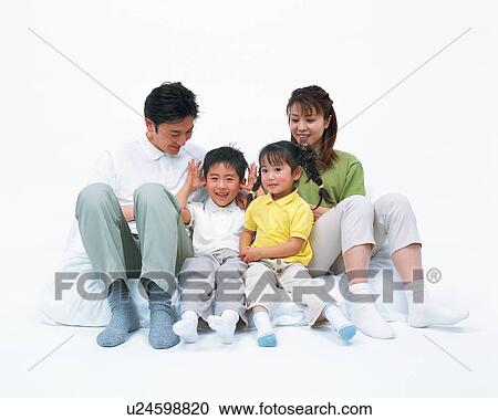 Stock Image - A happy family resting on mattress. Fotosearch