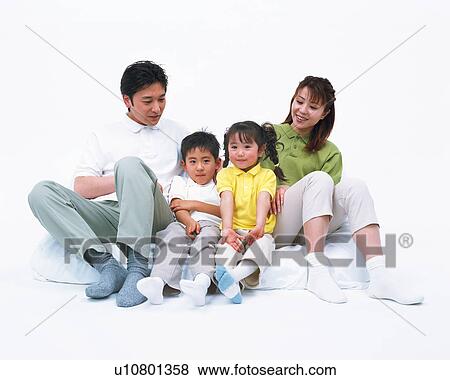 Stock Photo - A happy family resting on mattress. Fotosearch