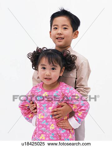 Stock Photography - A small boy holding his sister. Fotosearch