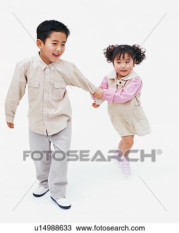 A small girl holding her brother's hand View Large Photo Image Stock Image - A small girl holding her brother's hand. Fotosearch